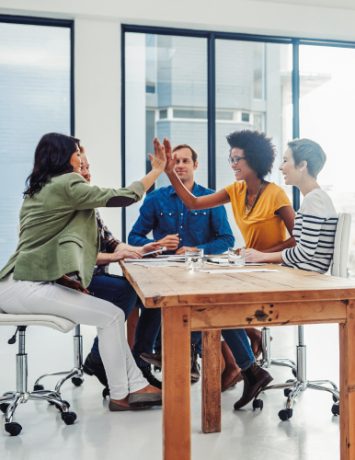 group-of-people-touching-your-hands-on-a-table